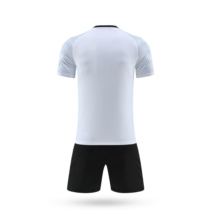 Rear view of white and black youth soccer uniform showing sleeve details and solid white back panel.