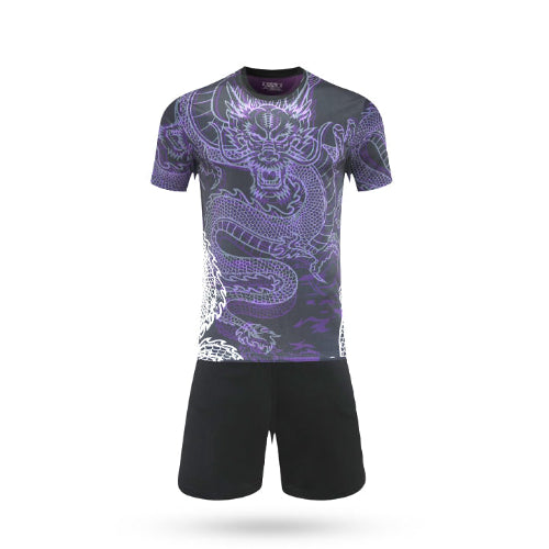 A dark purple Core Dribble soccer jersey featuring a vibrant neon purple dragon graphic on the front, paired with solid black athletic shorts.
