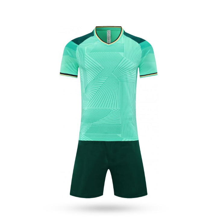 Complete set view of the Sky Break kids game mint green kit featuring a white gradient pattern with dark green short.