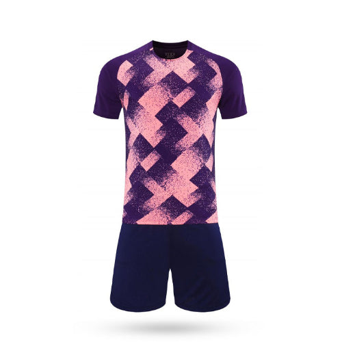 Purple and pink Torque Pass soccer jersey featuring a bold geometric diamond pattern and navy shorts.